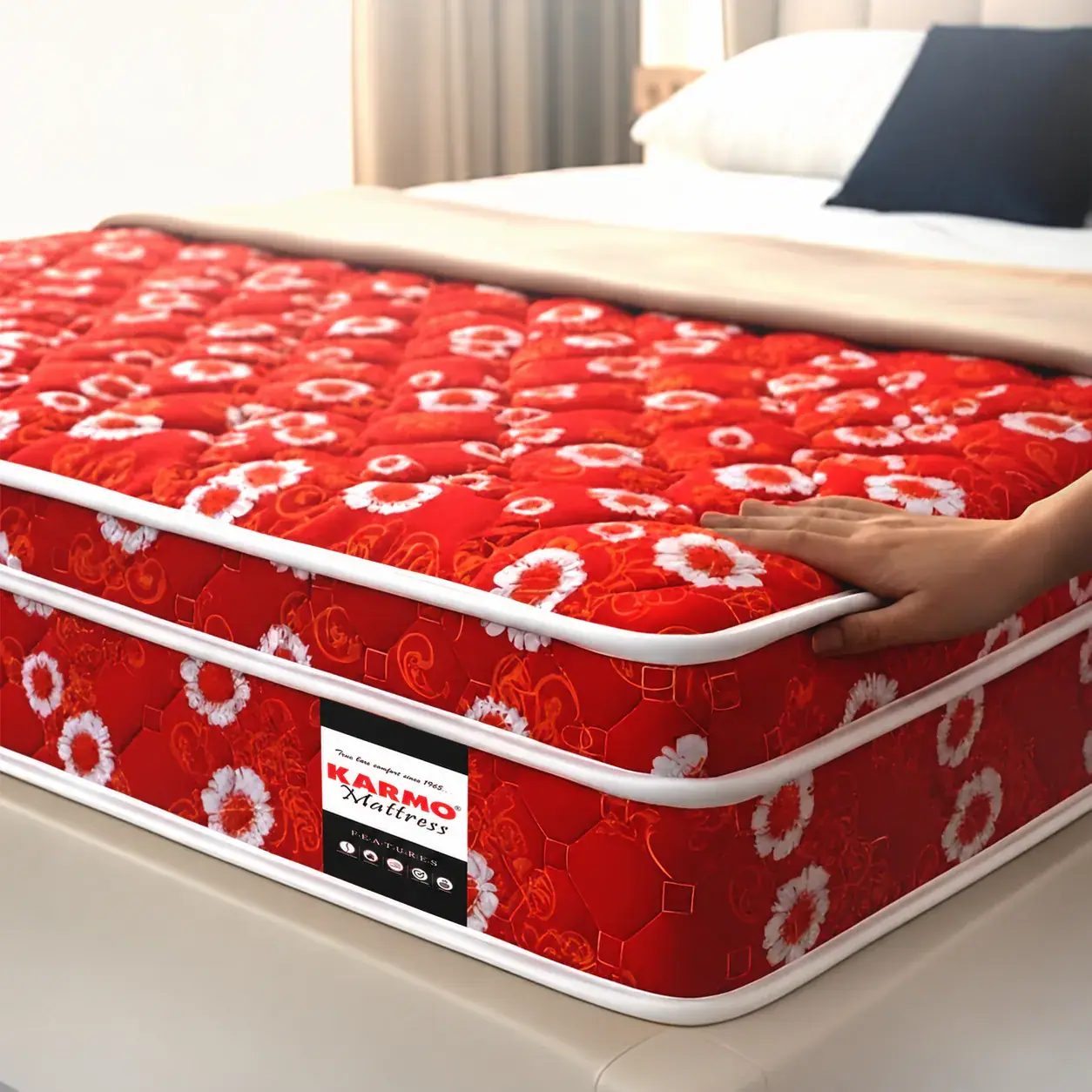 Hand pressing a red floral quilted Karmo mattress