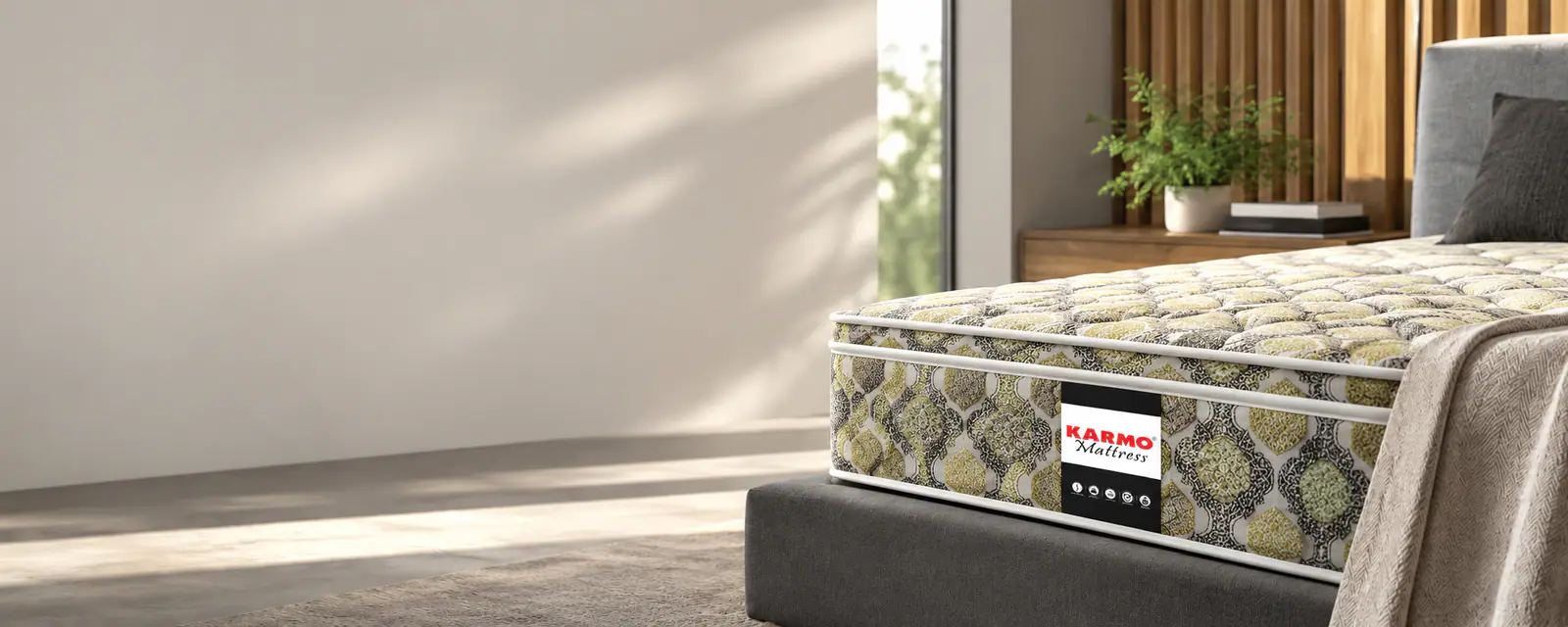 A Karmo quilted mattress on a bed in a bright, sunlit bedroom